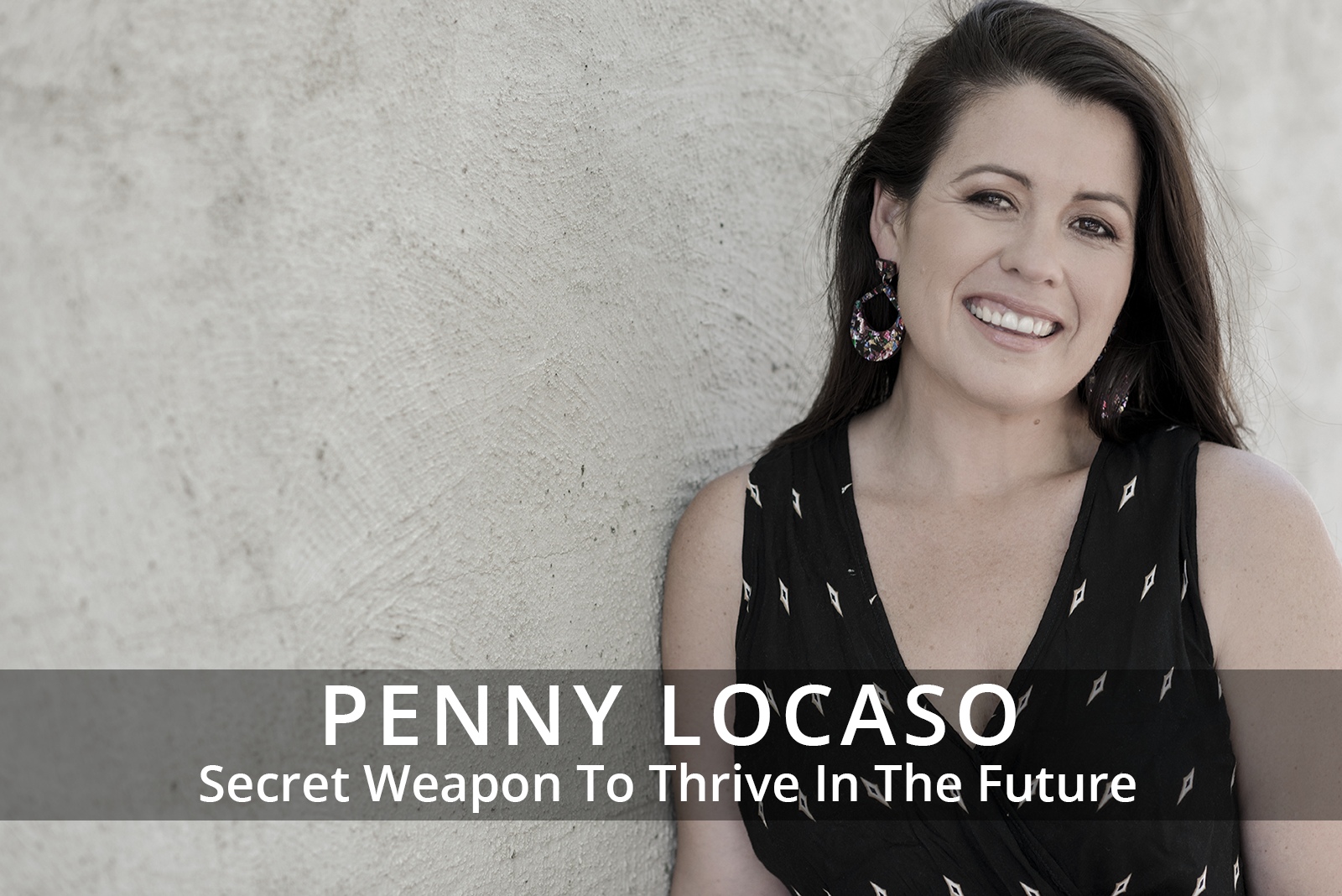 Female participants in a workshop sit in front of a graffiti wall.