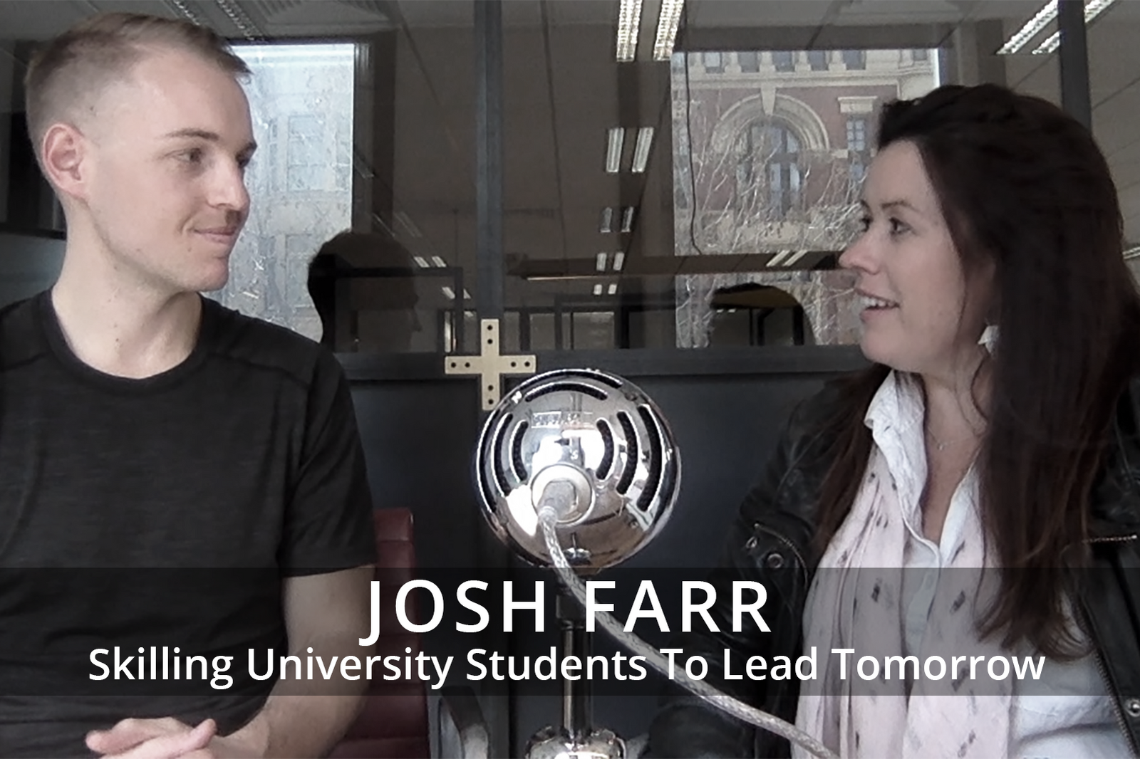 Female participants in a workshop sit in front of a graffiti wall.