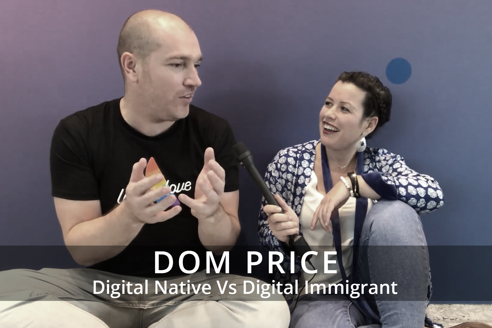 Female participants in a workshop sit in front of a graffiti wall.