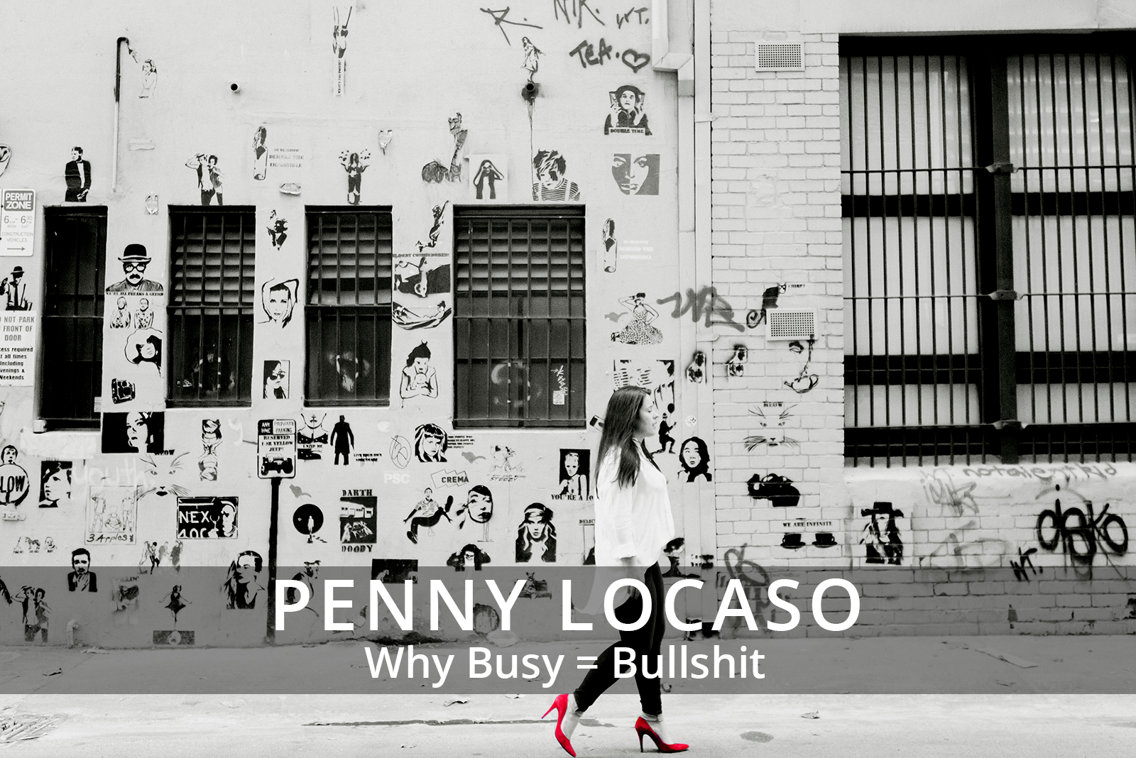 Female participants in a workshop sit in front of a graffiti wall.