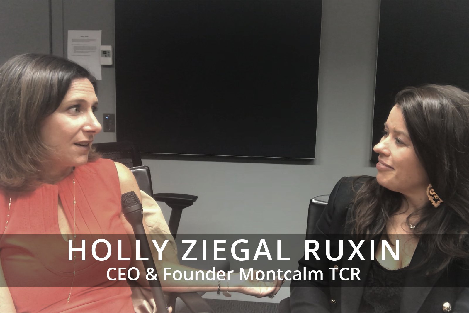 Female participants in a workshop sit in front of a graffiti wall.