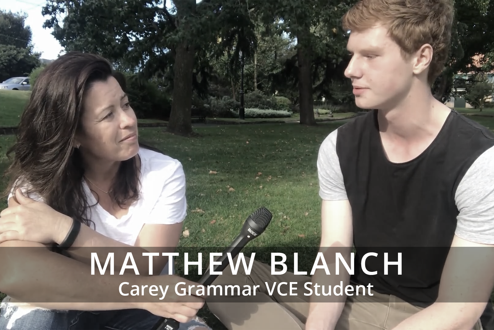 Female participants in a workshop sit in front of a graffiti wall.