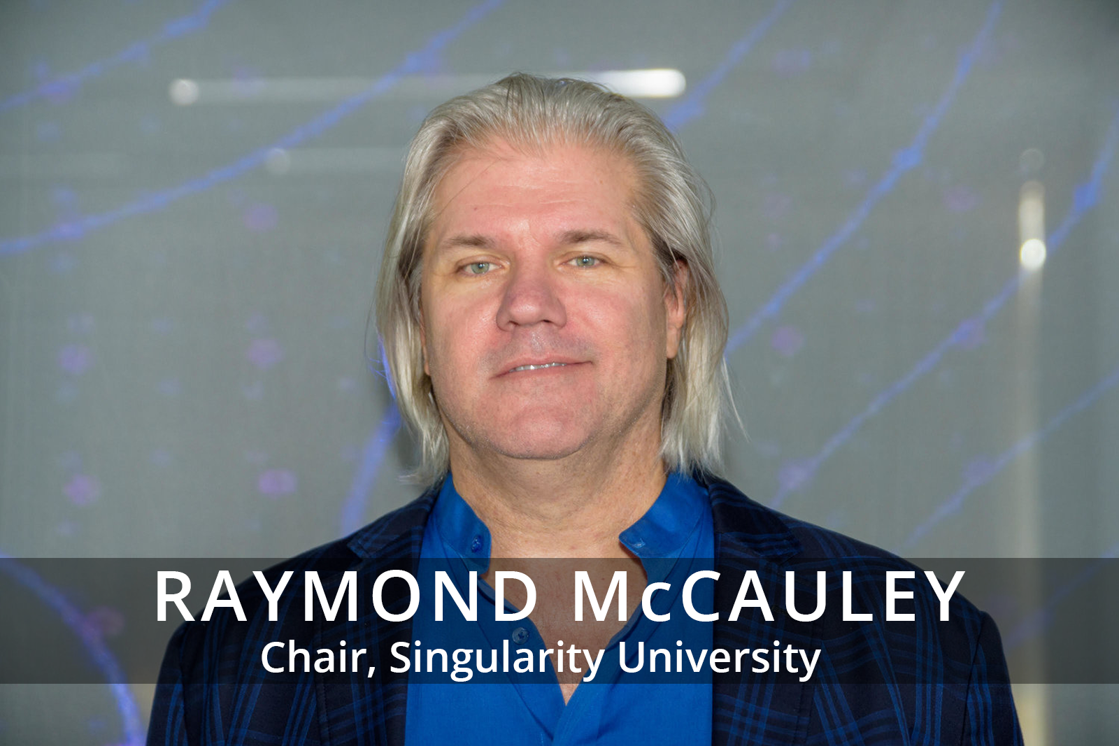 Female participants in a workshop sit in front of a graffiti wall.