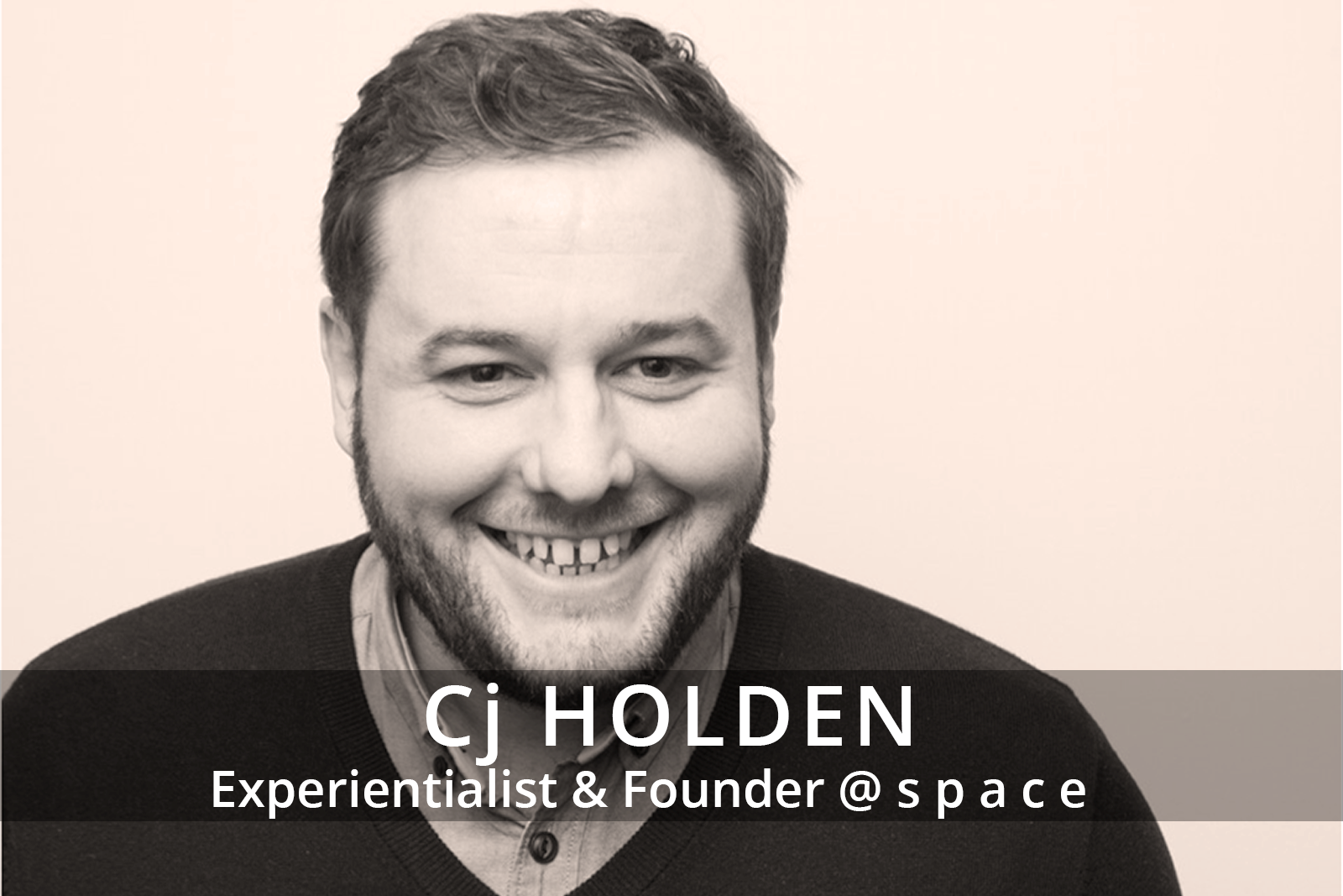 Female participants in a workshop sit in front of a graffiti wall.