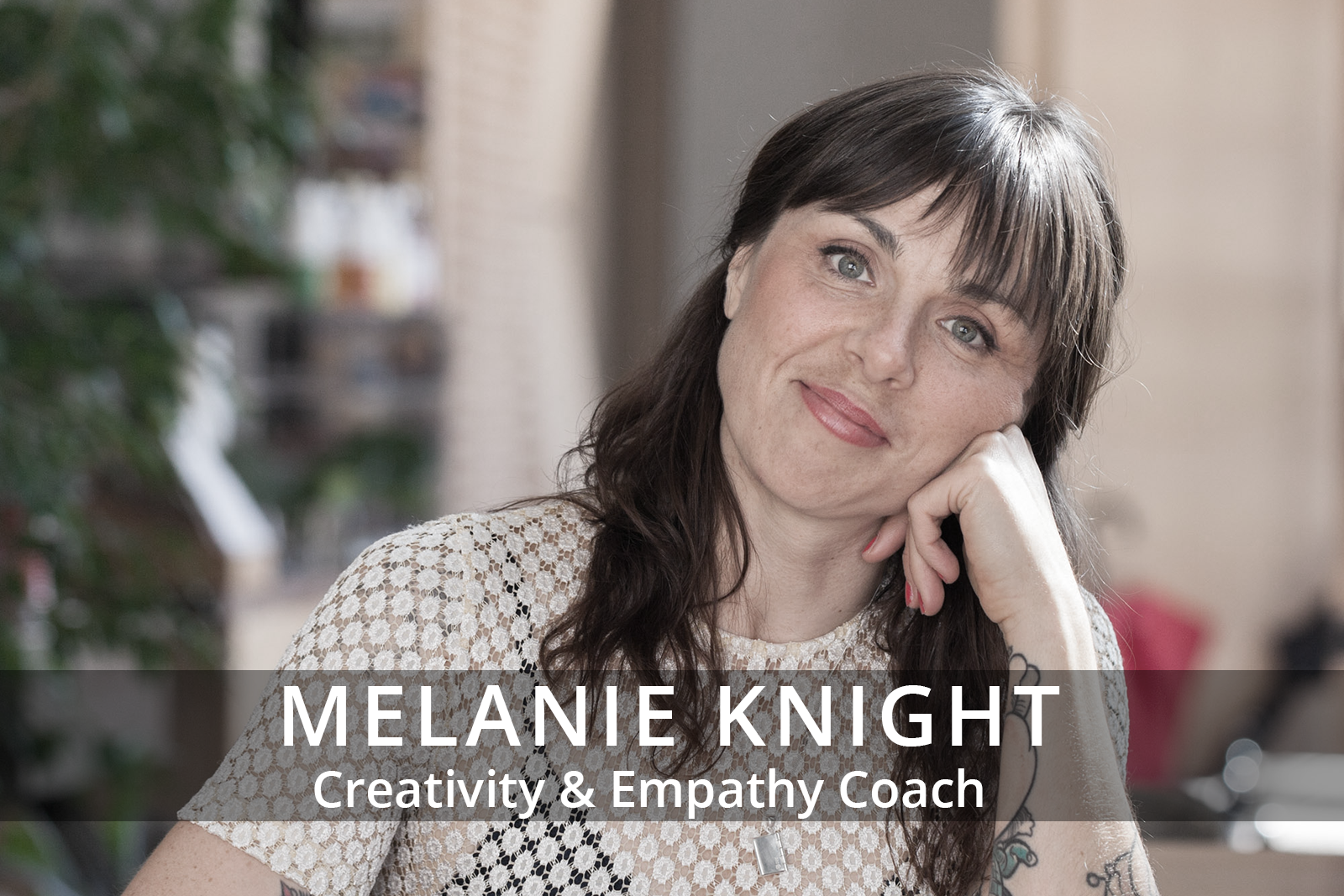 Female participants in a workshop sit in front of a graffiti wall.