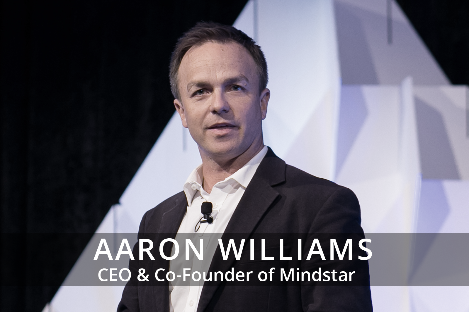Female participants in a workshop sit in front of a graffiti wall.