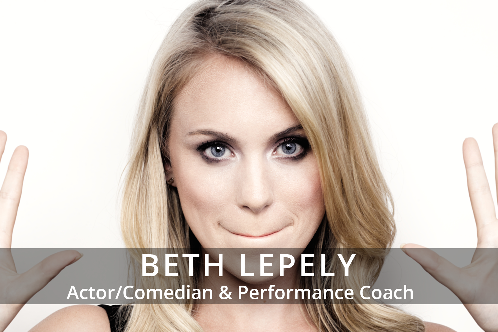 Female participants in a workshop sit in front of a graffiti wall.