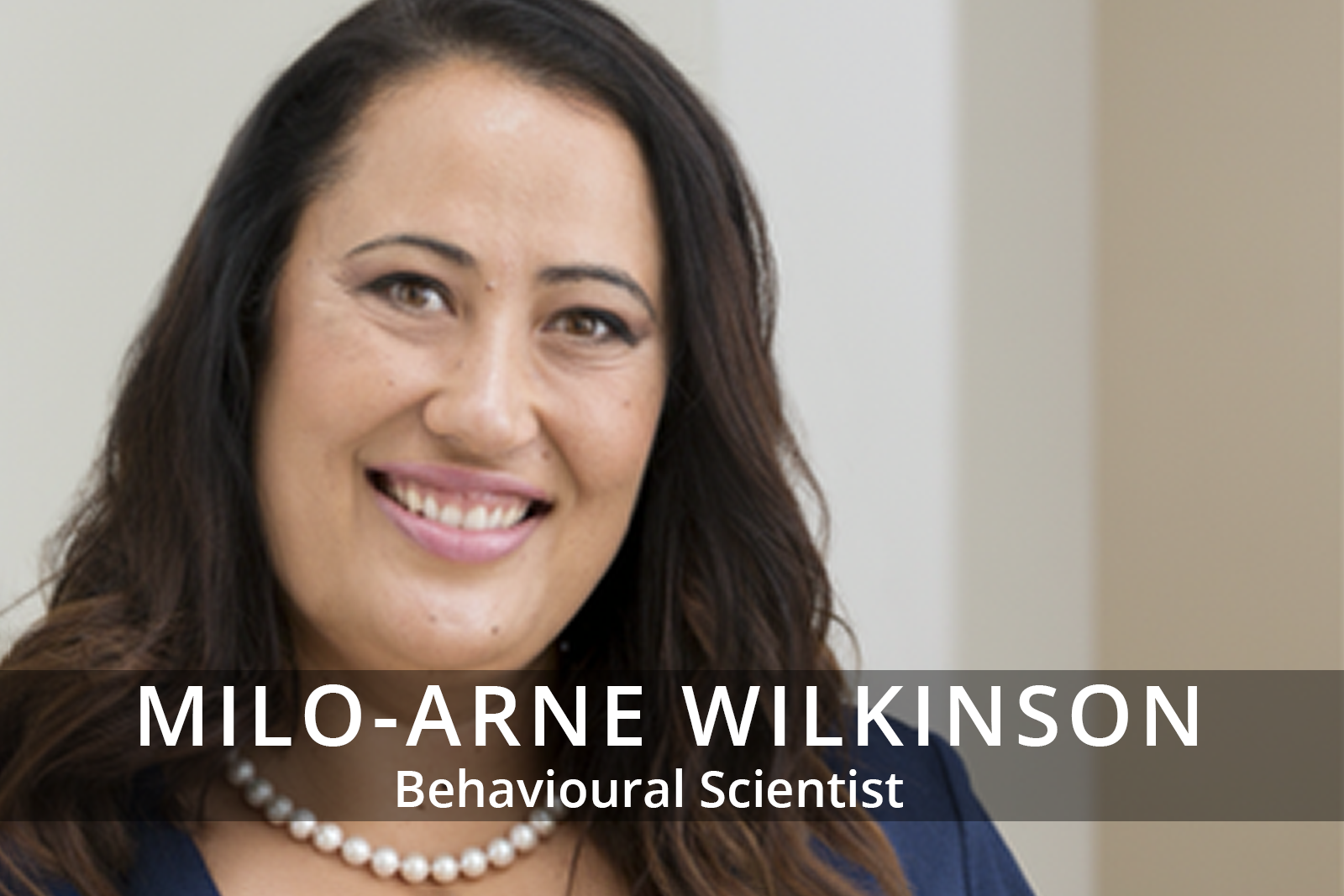 Female participants in a workshop sit in front of a graffiti wall.