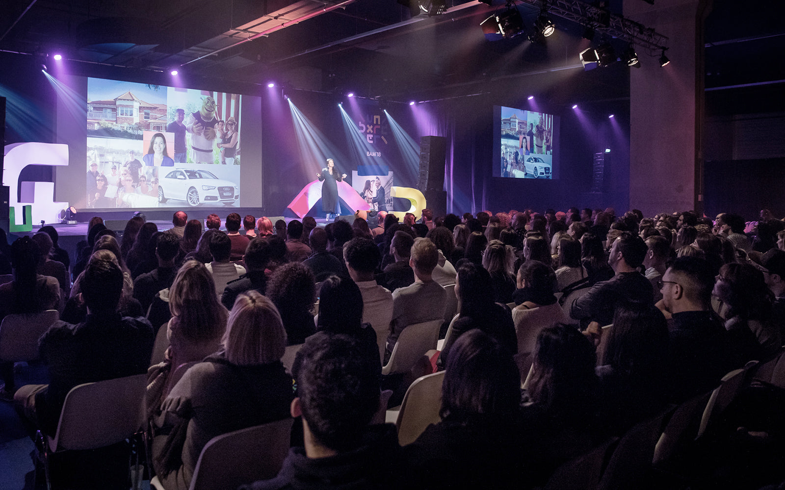 Female participants in a workshop sit in front of a graffiti wall.