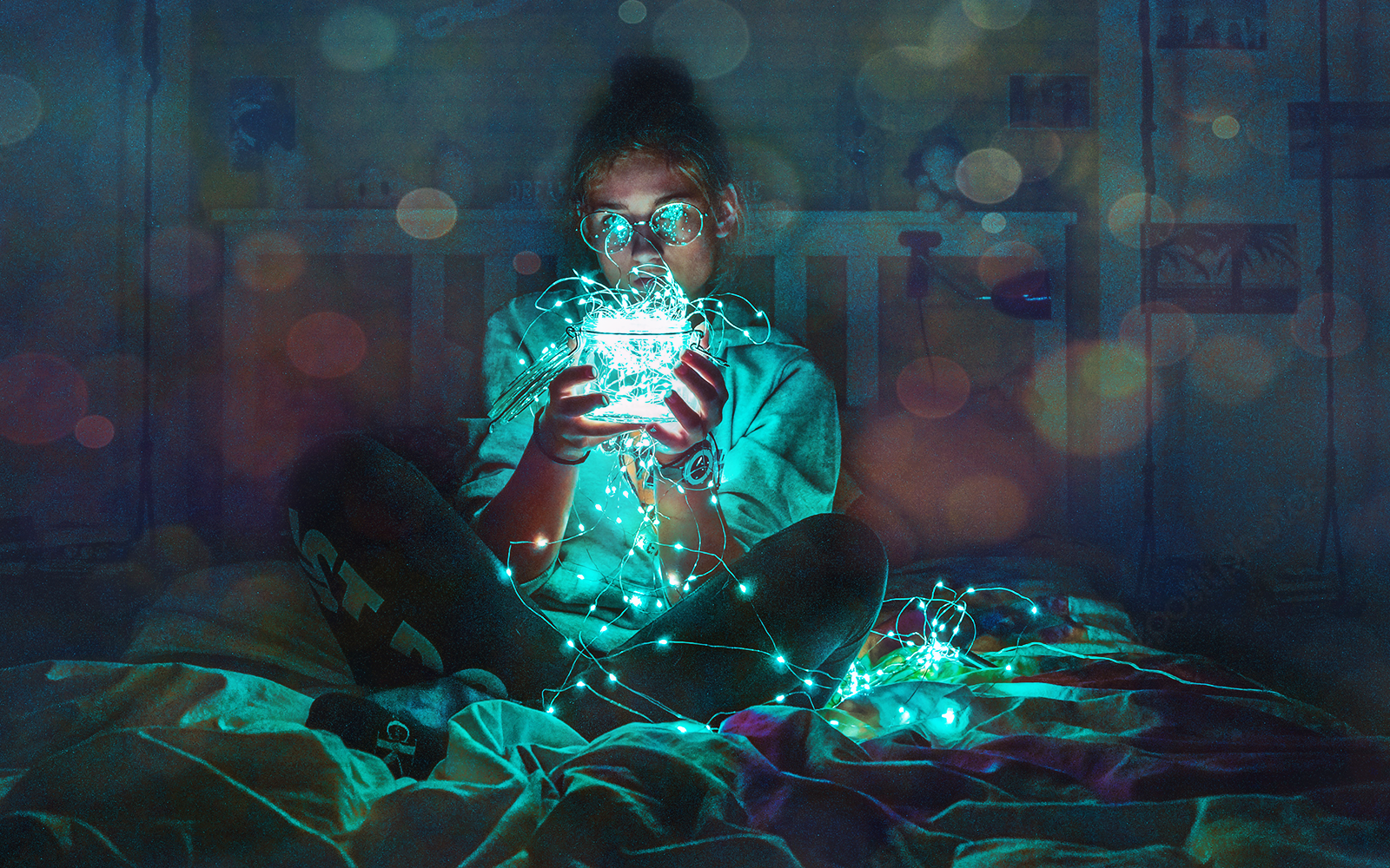 Female participants in a workshop sit in front of a graffiti wall.