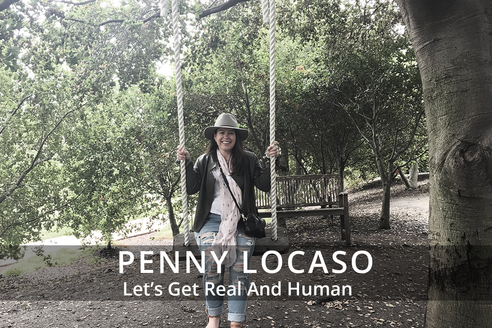 Female participants in a workshop sit in front of a graffiti wall.
