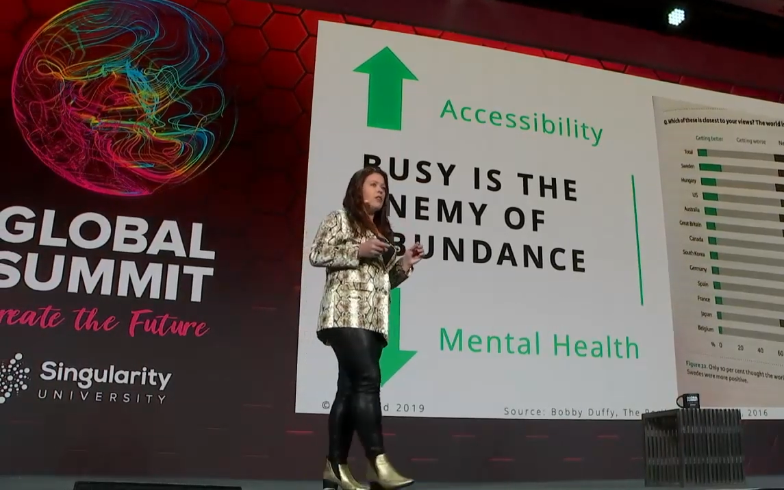 Female participants in a workshop sit in front of a graffiti wall.