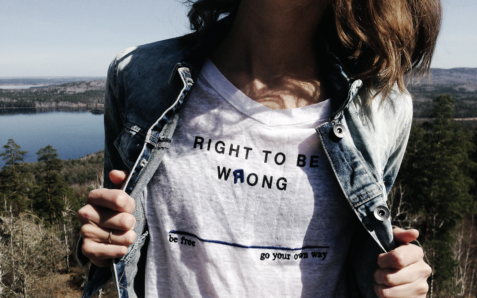 Female participants in a workshop sit in front of a graffiti wall.