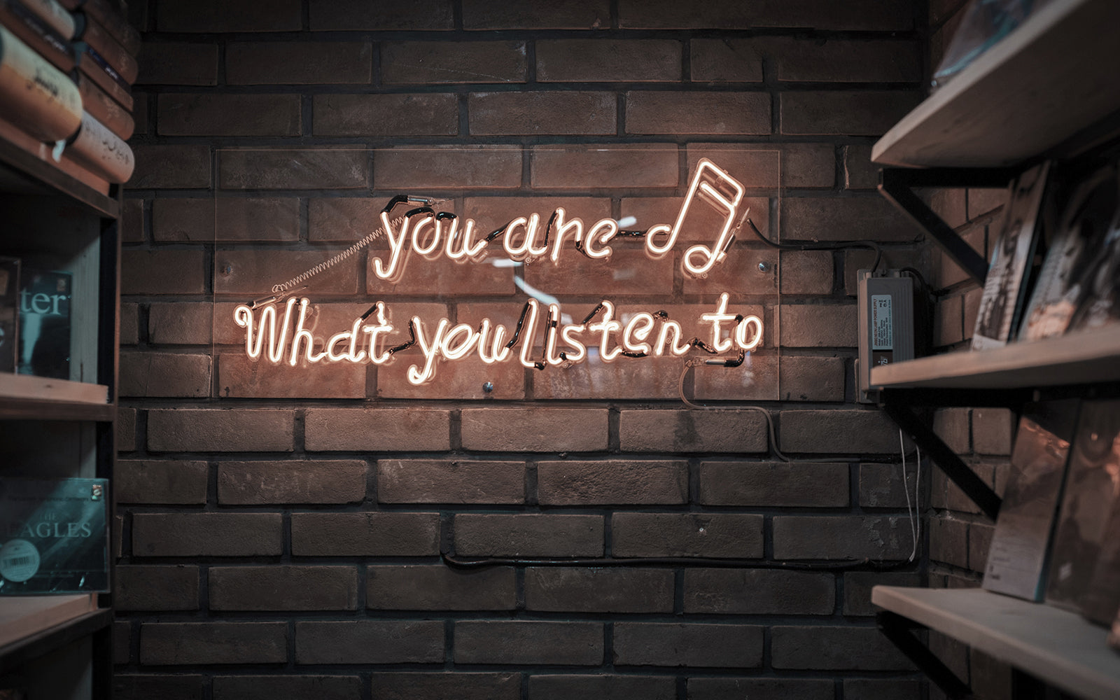 Female participants in a workshop sit in front of a graffiti wall.