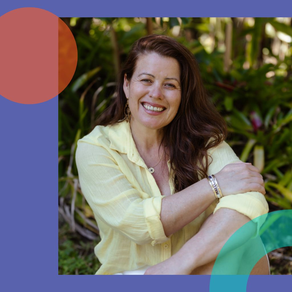 Woman is sitting and smiling.