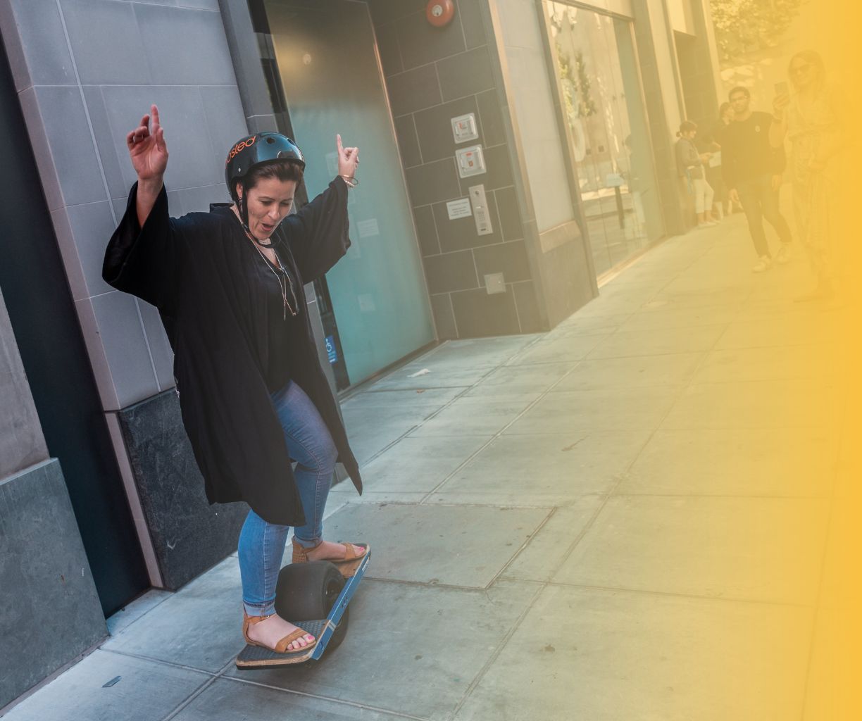 Free-spirited woman skateboarding.