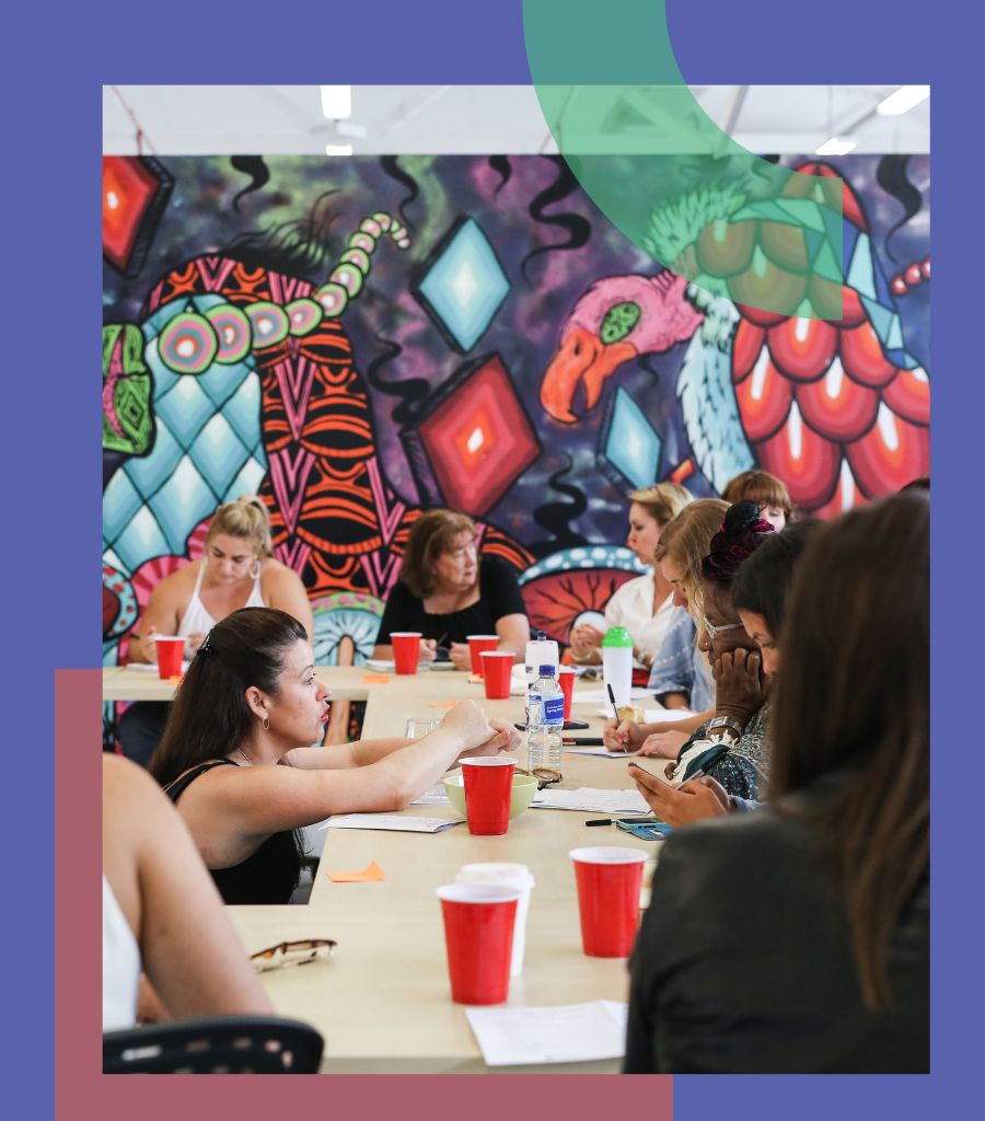 Woman is guiding a group of women during a workshop.